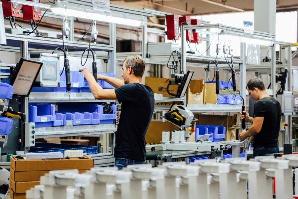 People working in assembly line in manufacturing