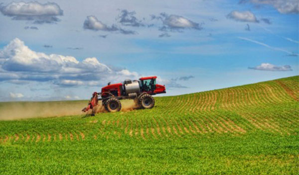 An Agriculture machine working on an open field